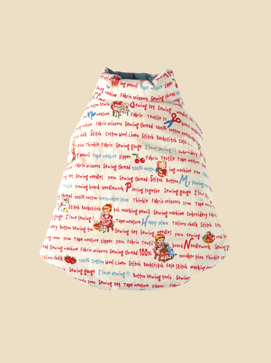Reversible down dog vest flat lay showing vintage-inspired illustrated side