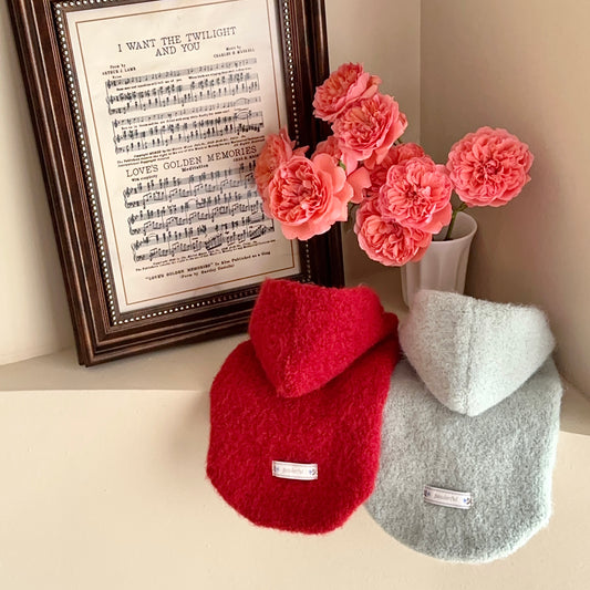 Red and green fuzzy hooded dog vest flat lay showing color options and cotton lining