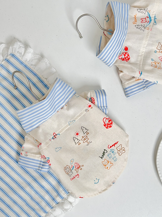 Flat lay of Camp Tales shirt featuring small animals camping illustration, soft premium pet clothing