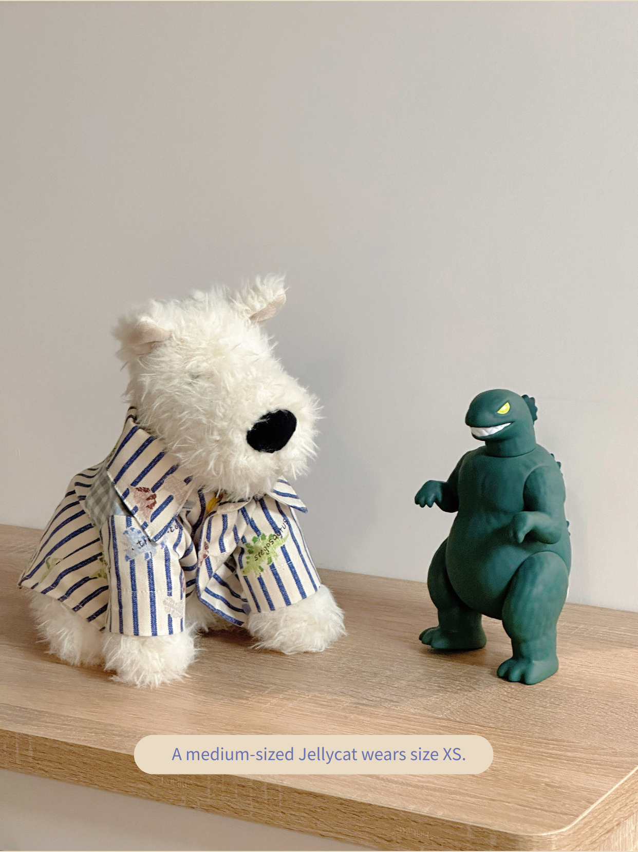 Medium-sized Jellycat Scottish Terrier wearing striped little dinosaur dog shirt